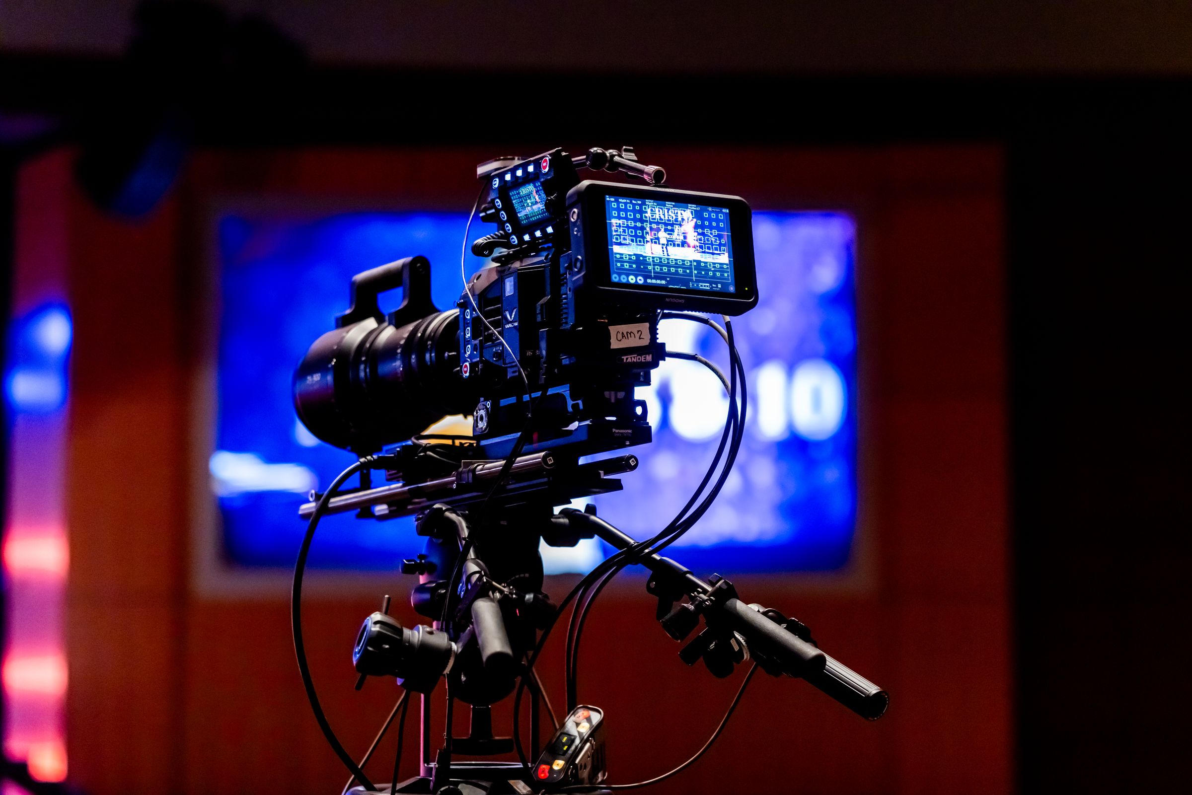 Video camera filming a stage event